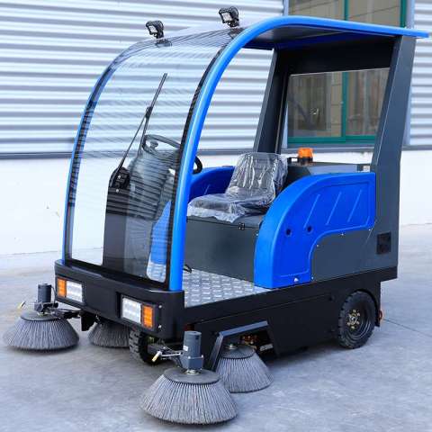 Fully enclosed electric ride on road sweeper